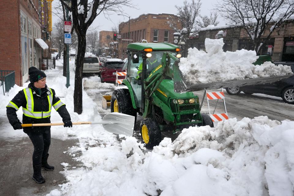 City workers pile up snow in Downtown Flagstaff on Jan. 16, 2023.