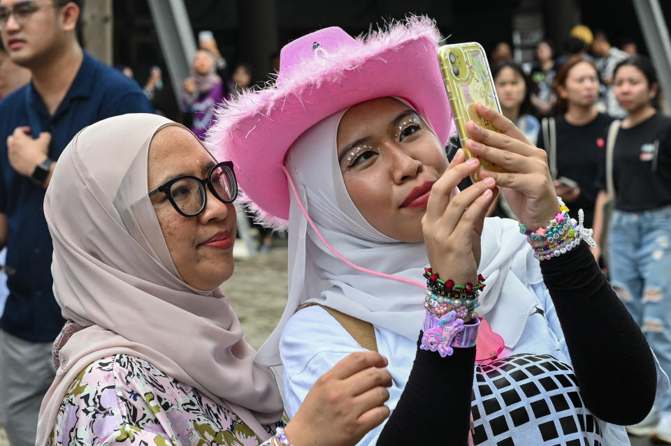 Fans of US singer Taylor Swift, also known as a Swifties, take photos as they arrive for the first of the pop star's six sold-out Eras Tour concerts at the National Stadium in Singapore on March 2, 2024. (Photo by Roslan RAHMAN / AFP) (Photo by ROSLAN RAHMAN/AFP via Getty Images)