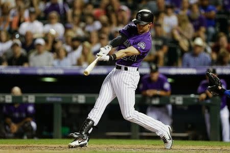 Aug 10, 2018; Denver, CO, USA; Colorado Rockies third baseman Ryan McMahon (24) hits a two run home run in the seventh inning against the Los Angeles Dodgers at Coors Field. Mandatory Credit: Isaiah J. Downing-USA TODAY Sports