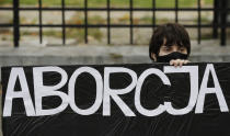 Pro-choice activists from "Women Strike" attend a protest in front of Poland's constitutional court, in Warsaw, Poland, Thursday, Oct. 22, 2020. Poland’s top court has ruled that a law allowing abortion of fetuses with congenital defects is unconstitutional. The decision by the country’s Constitutional Court effectively bans terminating pregnancies in cases where birth defects are found and will further limit access to abortions in Poland. (AP Photo/Czarek Sokolowski)