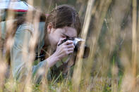 Olivia Chaffin makes photographs in a wooded area as she works on a Girl Scout photography merit badge in Jonesborough, Tenn., on Sunday, Nov. 1, 2020. (AP Photo/Mark Humphrey)