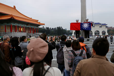 Tourists attend a flag-lowering ceremony at Chiang Kai-shek Memorial Hall in Taipei, Taiwan January 22, 2019. Picture taken January 22, 2019. REUTERS/Tyrone Siu