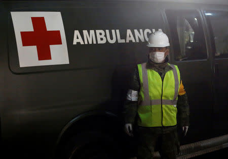 A soldier stands guard by a van, next to a collapsed building, after an earthquake in Mexico City, Mexico September 25, 2017. REUTERS/Henry Romero