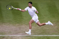 Serbia's Novak Djokovic returns to Russia's Andrey Rublev in a men's singles match on day nine of the Wimbledon tennis championships in London, Tuesday, July 11, 2023. (AP Photo/Alberto Pezzali)