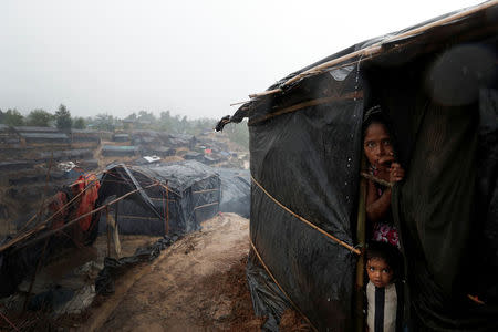 Rohingya refugees look out from a shelter in Cox's Bazar, Bangladesh, September 17, 2017. REUTERS/Cathal McNaughton