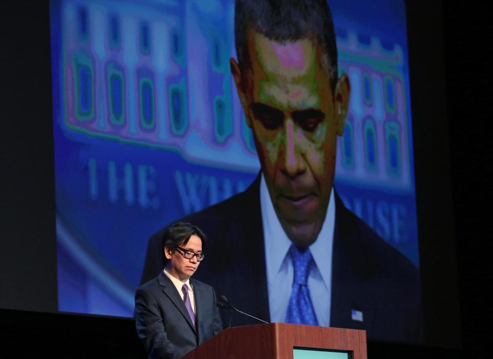 Charles Dharapak, the chief White House photographer for The Associated Press, projects one of his AP photographs of President Barack Obama while speaking to editors and publishers at the Newspaper Association of America’s mediaXchange 2014 convention, in Denver, Tuesday, March 18, 2014. Dharapak talked about his experience of ongoing coverage limitations placed on news organizations by the Obama White House. (AP Photo/Brennan Linsley)