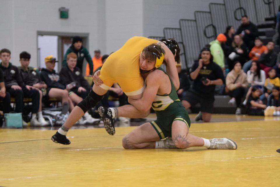 Pueblo County's Tony Macaluso shoots in for a takedown on Pueblo East's Kael Gonzales during their 144-pound matchup on Wednesday, January 3, 2024.