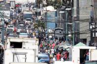 Pedestrians and motor traffic fill a street in the neighborhood of Catia despite a national quarantine in response to the spread of coronavirus disease (COVID-19), in Caracas