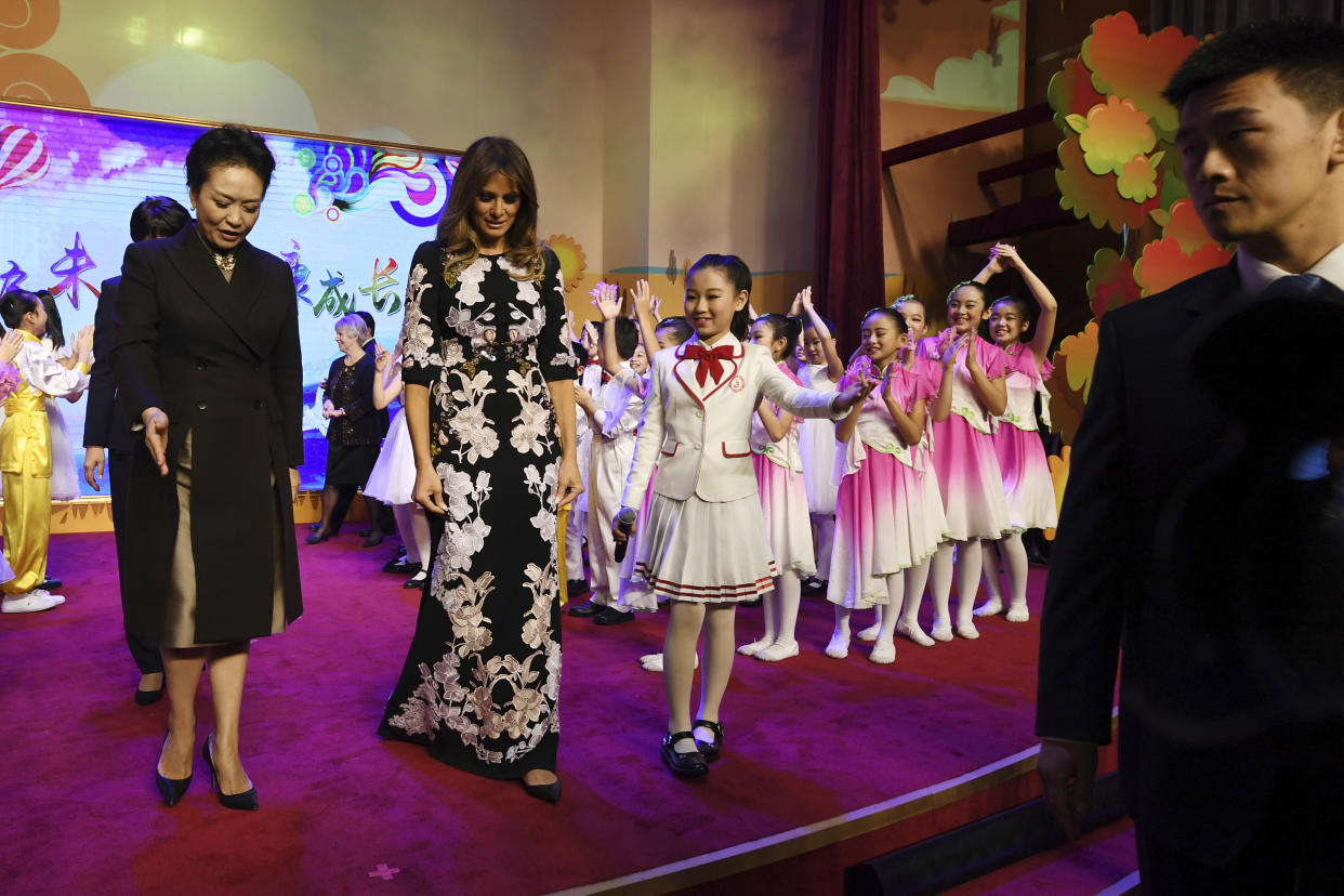 First lady Melania Trump and China’s first lady, Peng Liyuan, are escorted by a student after a cultural performance during a visit to the Banchang Primary School in Beijing on Nov. 9. (Photo: Greg Baker/Pool photo via AP)