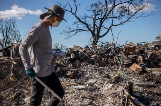 Spencer Kim helps clear debris at the ruins of a house belonging to a friend in Kula, Hawaii on Aug. 12, 2023. This small hillside town on Maui suffered damage from deadly fires that hit several parts of the island on Aug. 8.<span class="copyright">David Butow for TIME</span>