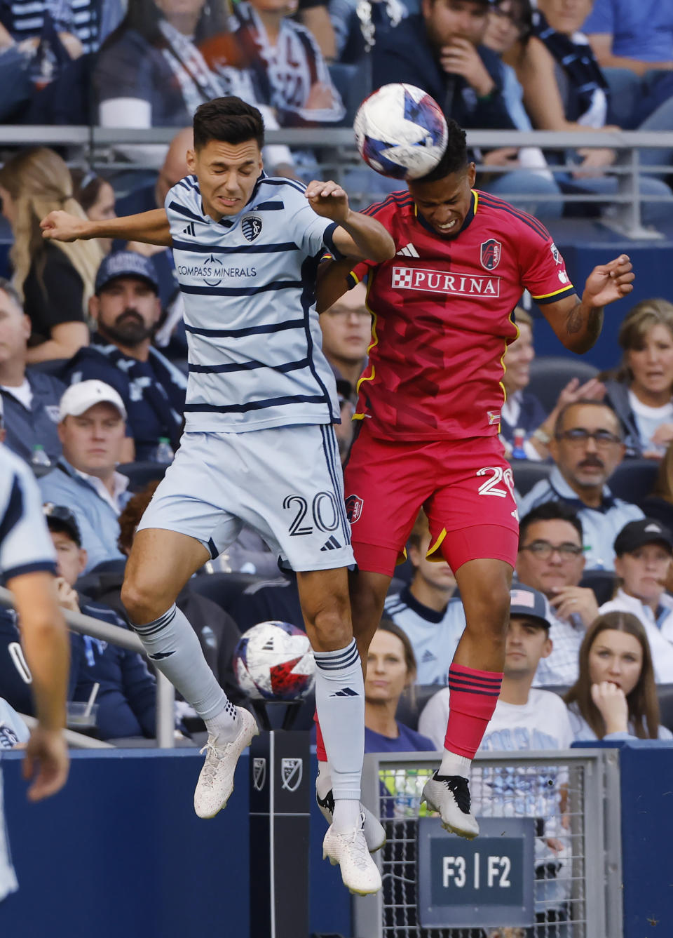 Sporting Kansas City forward Dániel Sallói (20) and St. Louis City defender Akil Watts, right, battle for the ball during the first half of an MLS playoff soccer match, Sunday, Nov. 5, 2023, in Kansas City, Kan. (AP Photo/Colin E. Braley)