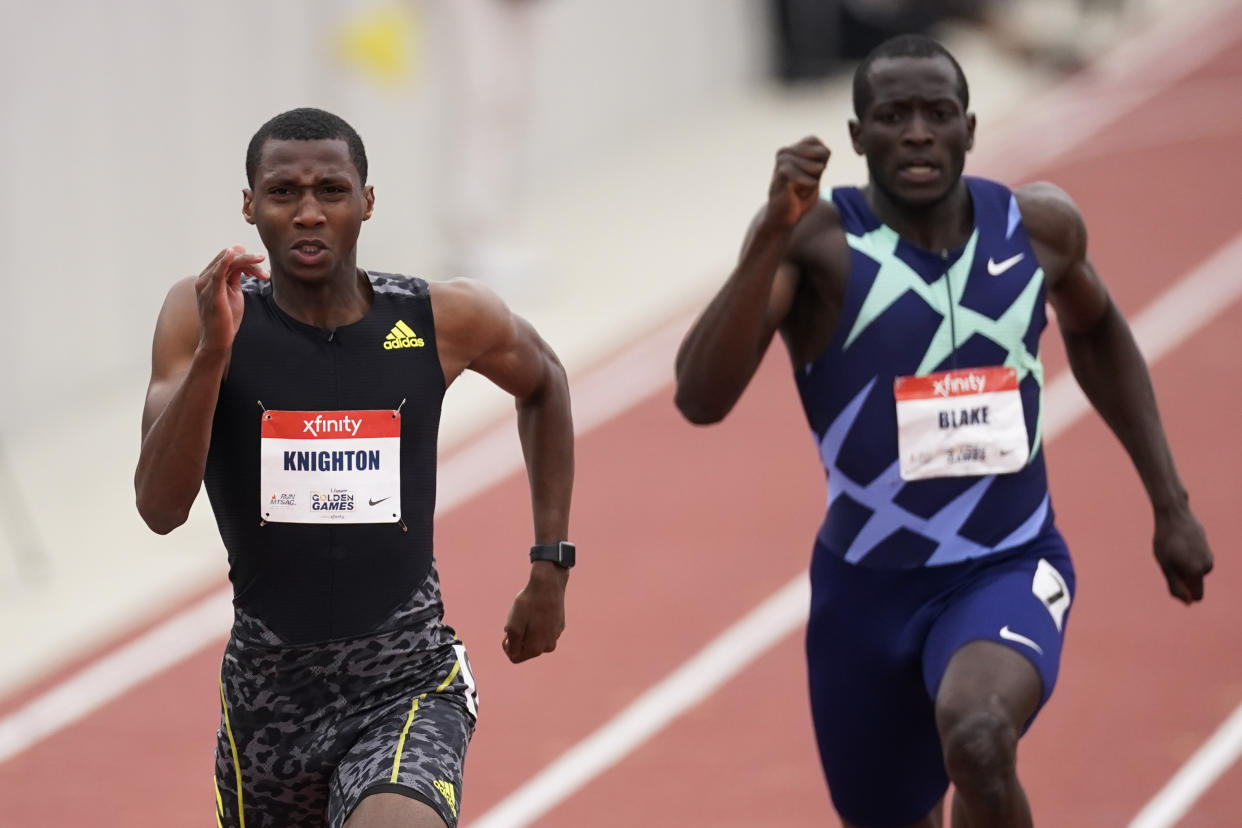 Erriyon Knighton, left, broke a junior record in the 200m that had been set by Usain Bolt in 2003. (AP Photo/Ashley Landis)