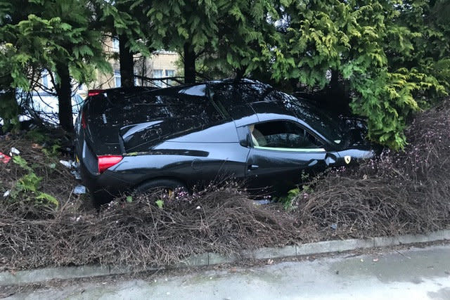 The Ferrari 458 Spider crashed in Bath, Somerset. See SWNS copy SWFERRARI: These shocking photographs show the trail of destruction caused when a Ferrari supercar ploughed into the front garden of a suburban house. The Ferrari 458 Spider, worth around Â£200,000,  left a roundabout, crossed the pavement and ended up wedged in a bush.It knocked down two bollards and sustained some damage in the process, in Bath, Somerset, at 7.40am on Saturday.