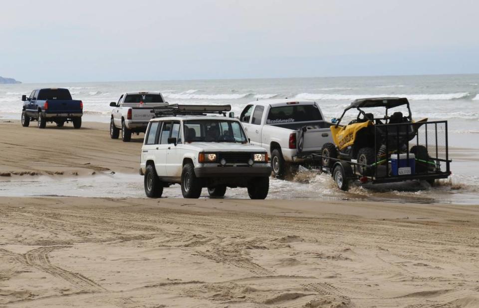 Vehicles cross Arroyo Grande Creek at the Oceano Dunes State Vehicular Recreation Area on Sunday, March 14, 2021. The Coastal Commission’s historic decision bans vehicles from crossing the creek when it’s flowing, which would cut off access to the majority of the park’s off-highway use.