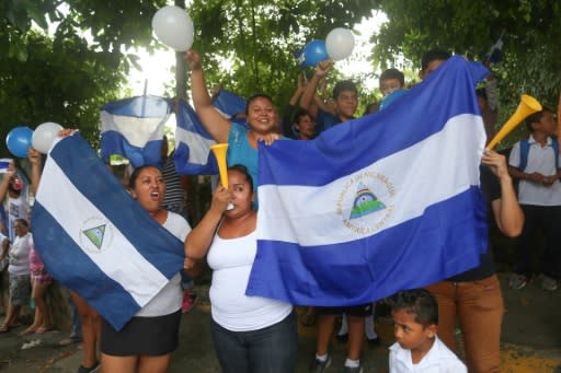 Friends and neighbours celebrate after student leader Edwin Carcache (not pictured) was released from prison, in Managua on June 11, 2019