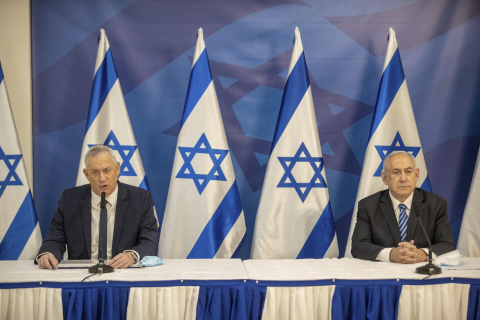 FILE - In July 27, 2020 file photo, Israeli Prime Minister Benjamin Netanyahu, right, and Israeli Defense Minister Benny Gantz issue a statement at the Israeli Defense Ministry in Tel Aviv, Israel. Israel is holding its fourth election in two years after two deadlocked votes and a government that collapsed after less than a year. It is widely seen as a one-issue referendum — with the electorate almost evenly divided — on whether longtime Prime Minister Benjamin Netanyahu can remain in power. (Tal Shahar/Yediot Ahronot, Pool via AP, File)