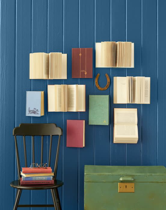 <p>Arrange books in a fun, slightly haphazard pattern, putting heavy-duty nails or staples through the back covers to secure. For extra texture, hold some pages open with string or fishing line.</p>