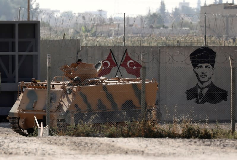 Turkish soldiers in an armored vehicle return from the Syrian town of Tal Abyad, as they are pictured on the Turkish-Syrian border in Akcakale