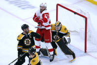 Detroit Red Wings' Michael Rasmussen (27) deflects a shot in front of Boston Bruins' Linus Ullmark, right, during the second period of an NHL hockey game Tuesday, Nov. 30, 2021, in Boston. (AP Photo/Michael Dwyer)