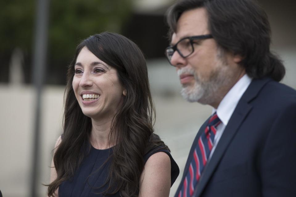 Michelle Susan Hadley stands with her attorney, Michael Guisti, as they address the media after being cleared of all charges in a complicated plot to frame her in Fullerton, Calif., Monday, Jan. 9, 2017. Hadley has been exonerated of charges that she placed "rape fantasy" ads on Craigslist in order to get men to attack her ex-boyfriend's new wife. Prosecutors now say that it was the alleged victim in the case who was trying to frame her husband's ex by placing the malicious ads. Her mother, Suzanne Hadley, is at left. (Jeff Gritchen/The Orange County Register via AP)