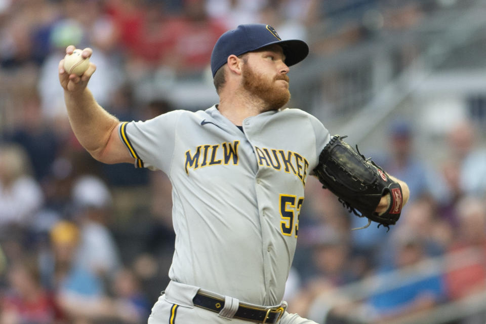 Milwaukee Brewers starting pitcher Brandon Woodruff throws against the Atlanta Braves during the first inning of a baseball game Saturday, July 31, 2021, in Atlanta. (AP Photo/Hakim Wright Sr.)