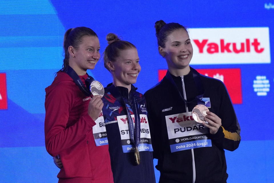 Gold medalist Laura Stephens of Britain, center, silver medalist Helena Rosendahl Bach of Denmark and bronze medalist Lana Pudar of Bosnia and Herzegovina pose for a photo during the medal ceremony for the women's 200-meter butterfly final at the World Aquatics Championships in Doha, Qatar, Thursday, Feb. 15, 2024. (AP Photo/Lee Jin-man)