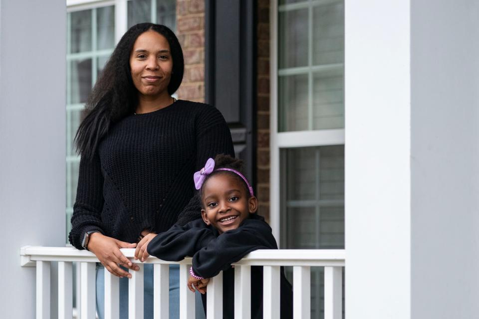 Vameka Davis stands with her daughter, Jax, 5, for a portrait outside their home. Davis served as the PTO president at Washington, D.C.'s Garrison Elementary School. Jax started school at Garrison in 2019.