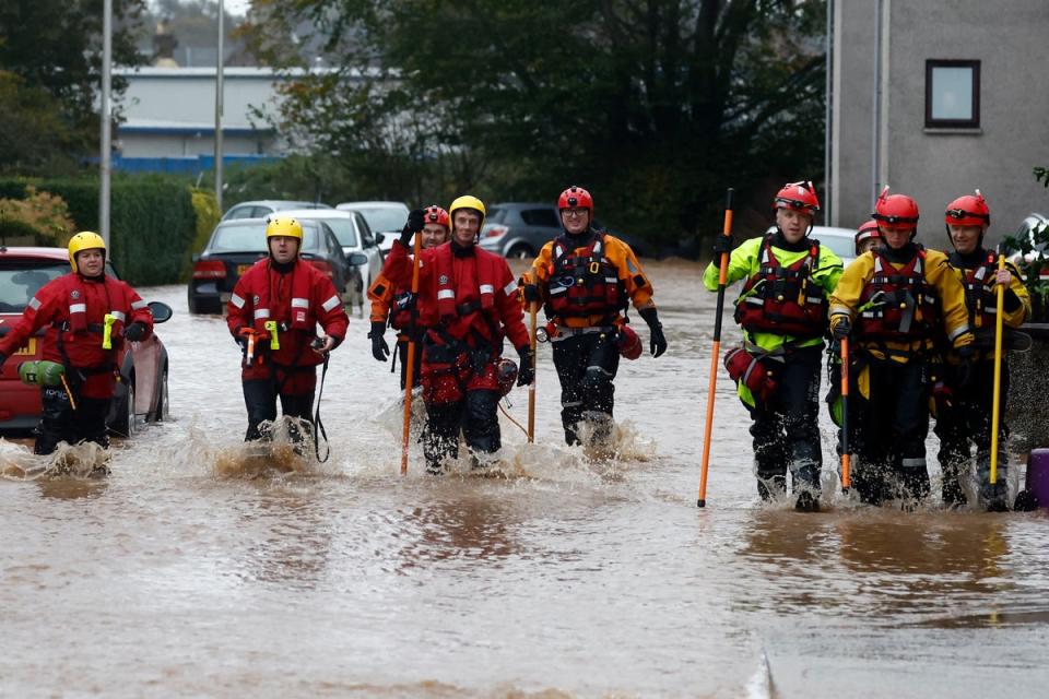 A rescue team wades through flood waters in Brechin where people were told to leave their homes (Getty Images)