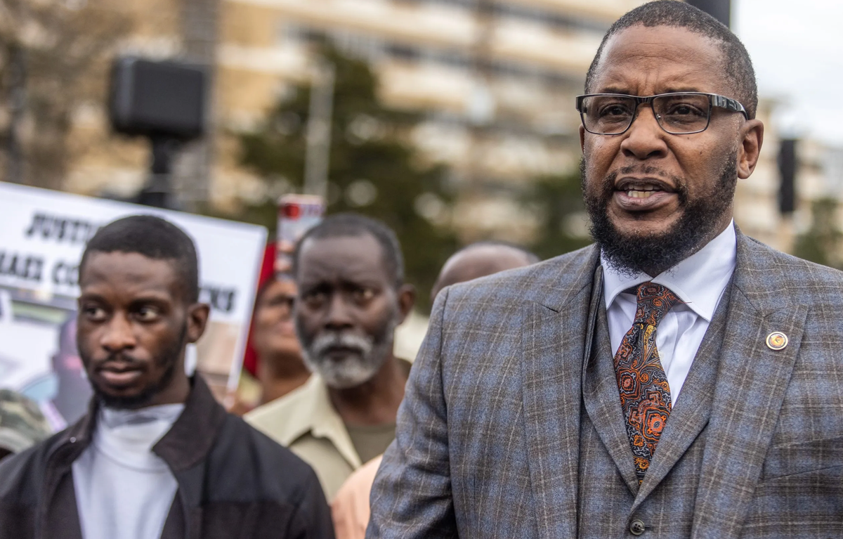 One of the victims, Michael Jenkins, with lawyer Malik Shabazz (Mississippi Today)