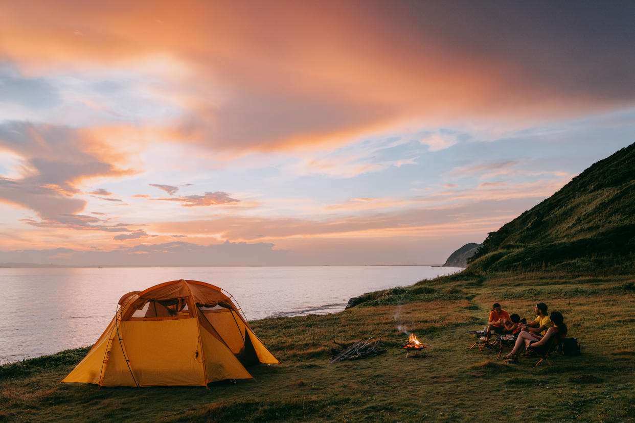 Family camping by the sea with dramatic sky at sunset, Chiba, Japan