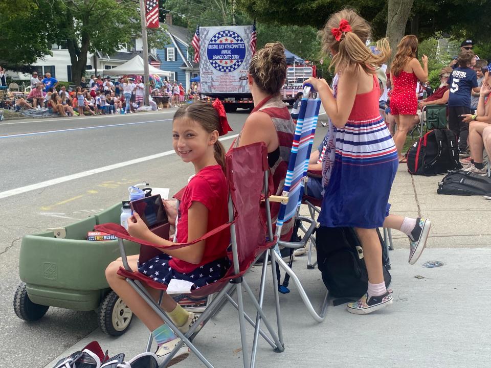 Abby Gallucci, 11, of Warwick, takes photos at Bristol's Fourth of July Parade to share with a friend who couldn't attend.