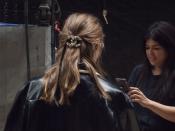 <p>Hairstylist Sam McKnight pulled models' hair into a rumpled half-up style and secured it with a length of black ribbon and an oversized logo pin. </p>