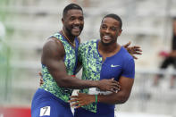 Isiah Young celebrates with Justin Gatlin, left, after winning his preliminary heat in the men's 100-meter dash at the U.S. Championships athletics meet, Thursday, July 25, 2019, in Des Moines, Iowa. (AP Photo/Charlie Neibergall)