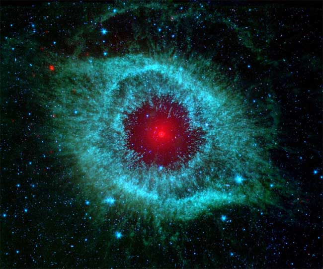 A red white dwarf shines at the center of a shimmering cloud of gas and dust in the Helix Nebula, located 700 light-years away in the constellation Aquarius.