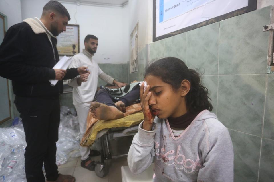 Palestinians wounded in the Israeli bombardment receive treatment in a hospital in Rafah, southern Gaza (AP)