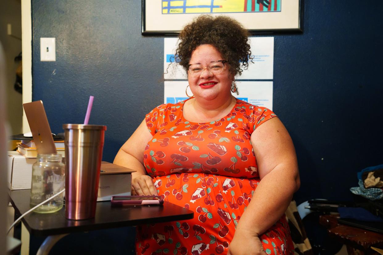 Tigress Osborn, board chair of the National Association to Advance Fat Acceptance, poses for a photo in her home on June 9, 2022, in Chandler, AZ. Osborne sits in the chair from which she often attends zoom meetings for the NAAFA.