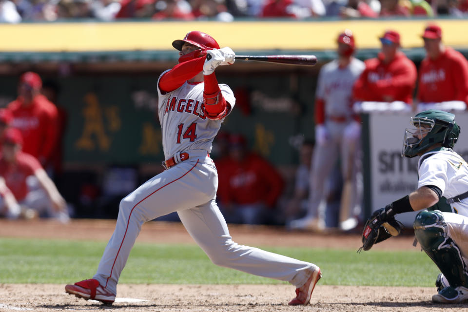 Los Angeles Angels' Logan O'Hoppe (14) hits a three-run home run in front of Oakland Athletics catcher Shea Langeliers, right, during the fourth inning of a baseball game in Oakland, Calif., Sunday, April 2, 2023. (AP Photo/Jed Jacobsohn)