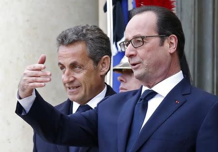 French President Francois Hollande (R) welcomes former French President Nicolas Sarkozy, head of the French conservative party UMP party, (L) at the Elysee Palace before attending a solidarity march (Marche Republicaine) in the streets of Paris January 11, 2015. REUTERS/Philippe Wojazer