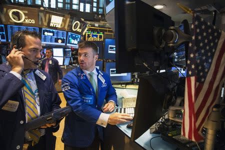 Traders work on the floor of the New York Stock Exchange shortly after the market's opening in New York July 28, 2014. REUTERS/Lucas Jackson