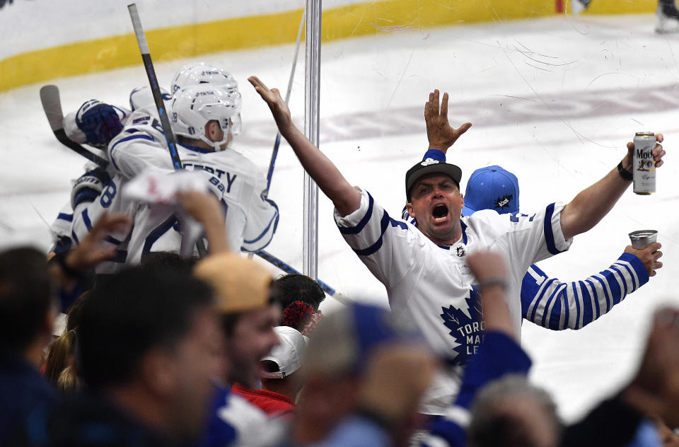 Toronto Maple Leafs fans and players celebrate a goal during the second period of Game 3 of an NHL hockey Stanley Cup second-round playoff series against the Florida Panthers, Sunday, May 7, 2023, in Sunrise, Fla. (AP Photo/Michael Laughlin)