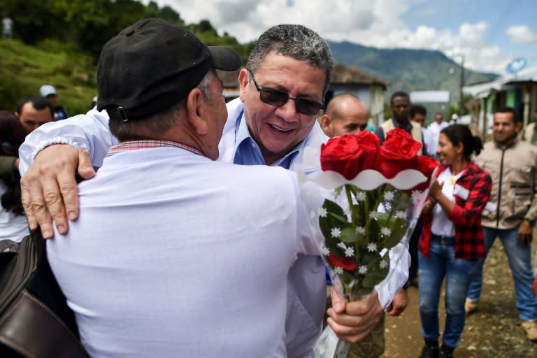 Pablo Catatumbo (R), a former leader of Colombia's largest guerrilla group, is now a candidate for the senate, seen here stumping for votes in a mountainous area where he once fought