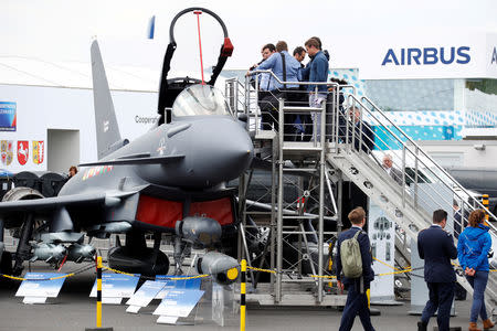 FILE PHOTO: Visitors look at the Eurofighter Typhoon jet during the ILA Air Show in Berlin, Germany, April 25, 2018. REUTERS/Fabrizio Bensch/File Photo