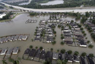 <p>Homes are surrounded by floodwaters from Tropical Storm Harvey Tuesday, Aug. 29, 2017, in Spring, Texas. (Photo: David J. Phillip/AP) </p>