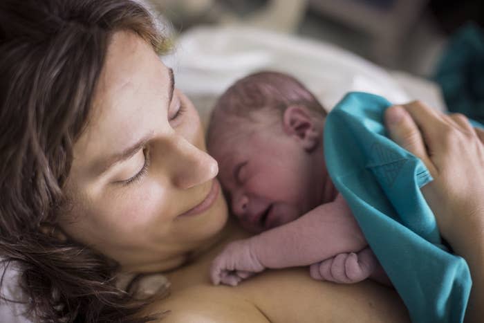 Woman holding newborn baby in hospital