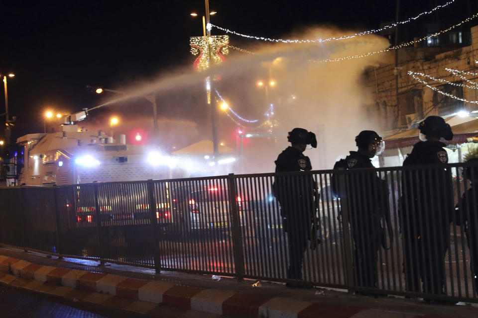 Israeli police use a water cannon to disperse Palestinian protesters from the area near the Damascus Gate to the Old City of Jerusalem after clashes at the Al-Aqsa Mosque compound, Friday, May 7, 2021. Palestinian worshippers clashed with Israeli police late Friday at the holy site sacred to Muslims and Jews, in an escalation of weeks of violence in Jerusalem that has reverberated across the region. (AP Photo/Mahmoud Illean)