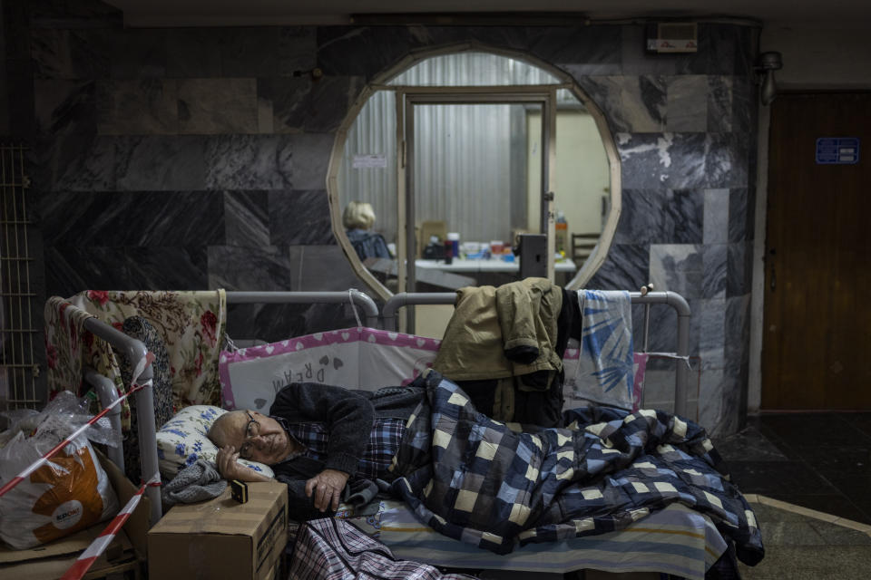 An elderly man rests in a city subway used as a temporary bomb shelter in Kharkiv, east Ukraine, Thursday, May 19, 2022. Although the bombings in Kharkiv have decreased and the subway is expected to run beginning of next week, still some residents use it as a temporary bomb shelter. (AP Photo/Bernat Armangue)