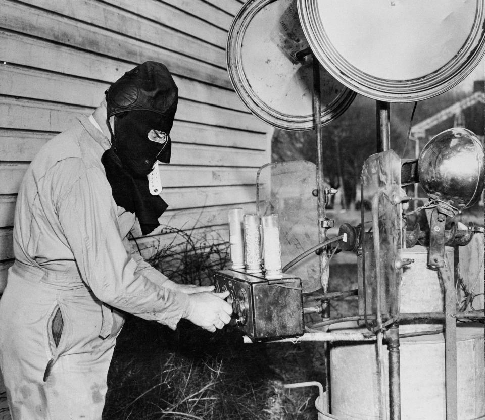 FILE - Chairman C.F. Hess, of the Hibernating Groundhog Lodge, dons a black hood as he tunes up what he says is an "ultra super-duper" invention, Jan. 31, 1947, in Quarryville, Pa. The invention would be used by lodge members to contact 10,672 registered groundhogs at their weather forecasting holes. The arrival of annual Groundhog Day celebrations Friday, Feb. 2, 2024, will draw thousands of people to see celebrity woodchuck Phil at Gobbler's Knob in Punxsutawney, Pa. — an event that exploded in popularity after the 1993 Bill Murray movie. (AP Photo, File)