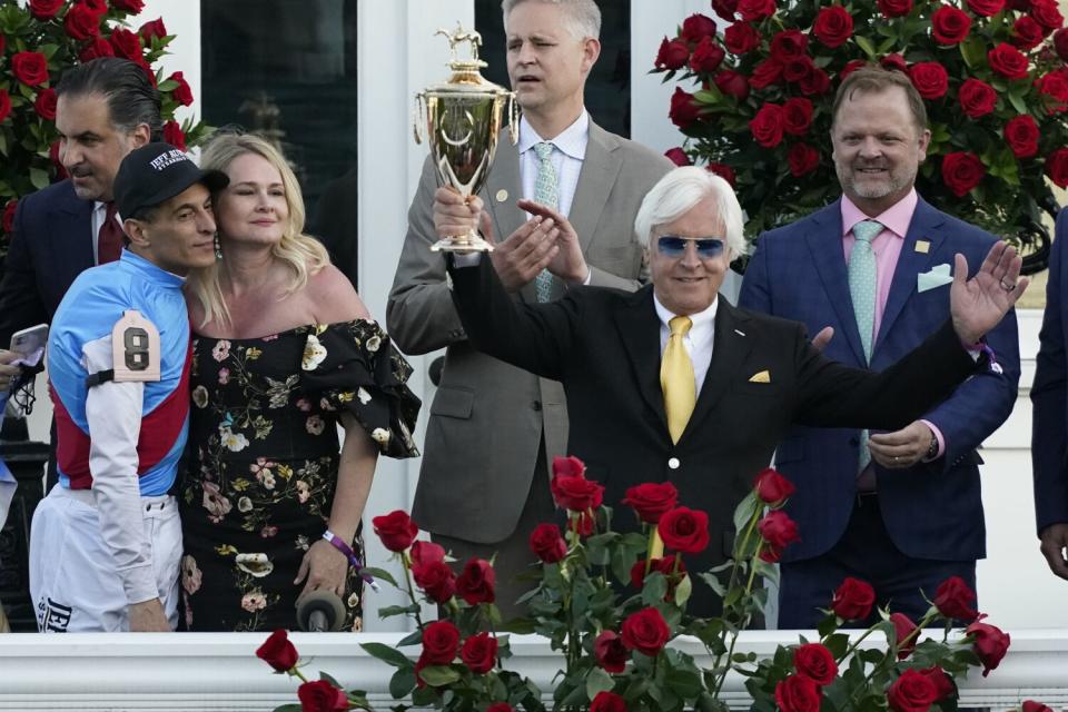 Trainer Bob Baffert holds up the winner's trophy after Medina Spirit's Kentucky Derby win on May 1, 2021