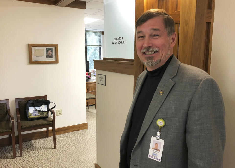 In this photo taken Wednesday, July 3, 2019, Oregon Sen. Brian Boquist poses outside his office in the Oregon State Capitol in Salem, Ore., after an interview with The Associated Press. Boquist once worked in the world's hotspots as a military contractor and soldier and now finds himself under fire, this time from fellow lawmakers and the governor after he threatened state police and the Senate president ahead of a walkout by Republican lawmakers. A Senate special committee on conduct will hold a hearing Monday, July 8, 2019, over Sen. Boquist's behavior. (AP Photo/Andrew Selsky)