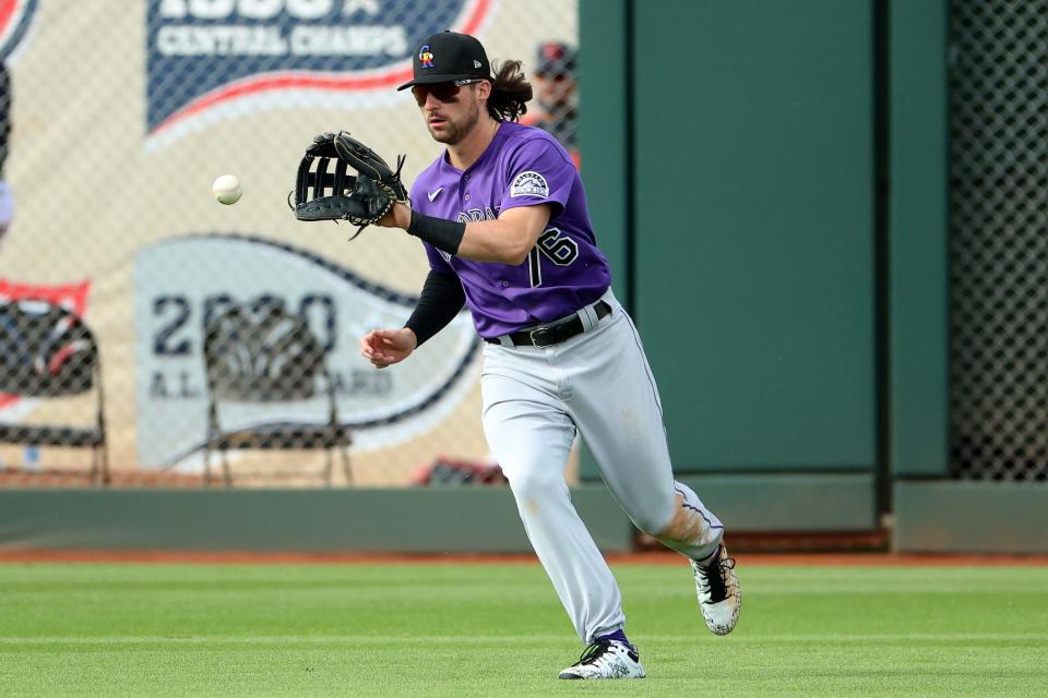 Ryan Vilade of the Colorado Rockies catches a fly out in the eighth inning against the Cleveland Indians during an MLB spring training game March 26, 2021 in Goodyear, Arizona.